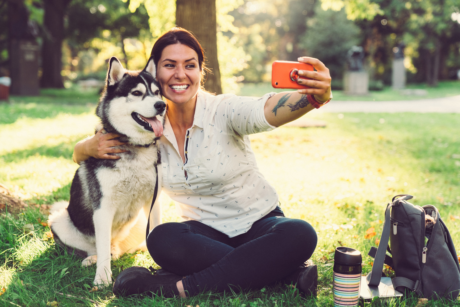 Pet owner with dog taking selfie